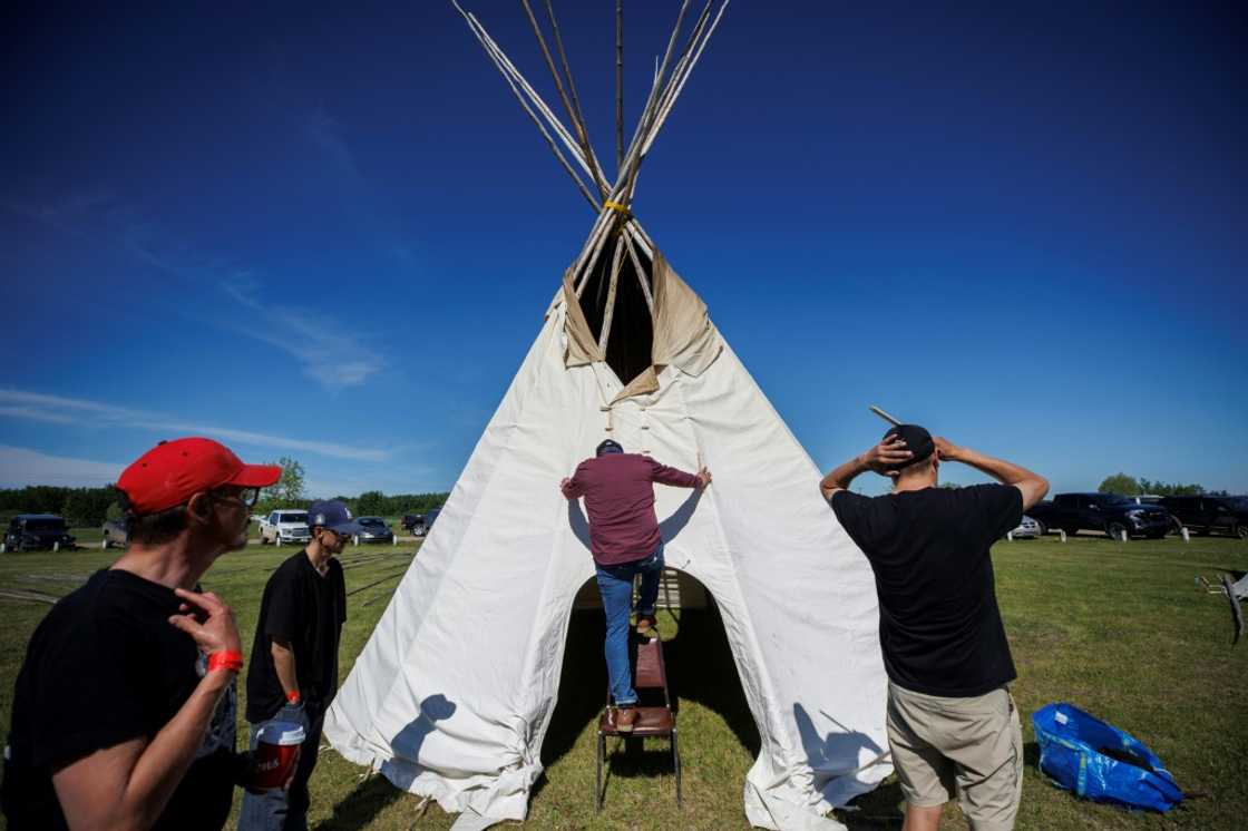 Volunteers on June 7 assemble a teepee in Maskwa Park in Maskwacis, Alberta ahead of Pope Francis's historic end of July visit to Canada in which he is to offer apologies for more than a century of abuses at Indigenous residential schools Volunteers on June 7 assemble a teepee in Maskwa Park in Maskwacis, Alberta ahead of Pope Francis's historic end of July visit to Canada in which he is to offer apologies for more than a century of abuses at Indigenous residential schools