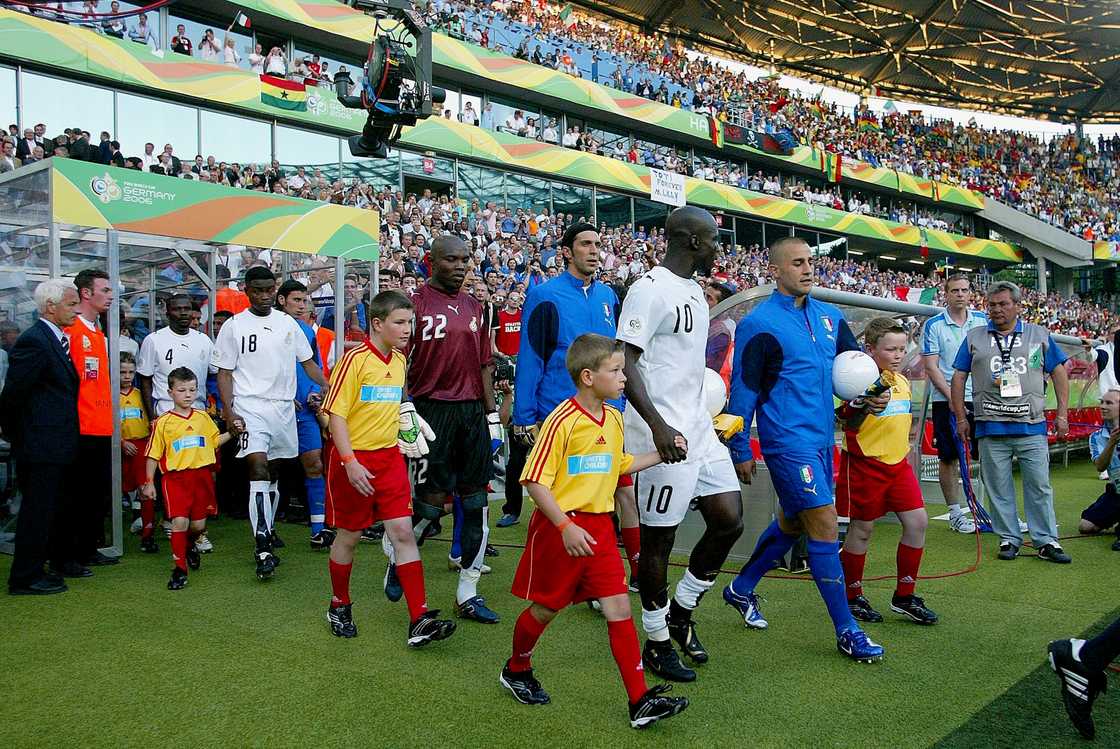 Stephen Appiah of Ghana, Fabio Cannavaro of Italy and Teams Walk onto the pitch before the FIFA World Cup Finals 2006 Group E match between Italy and Ghana at Niedersachsenstadion on June 12, 2006 in Hanover, Germany Stephen Appiah of Ghana, Fabio Cannavaro of Italy and Teams Walk onto the pitch before the FIFA World Cup Finals 2006 Group E match between Italy and Ghana at Niedersachsenstadion on June 12, 2006 in Hanover, Germany