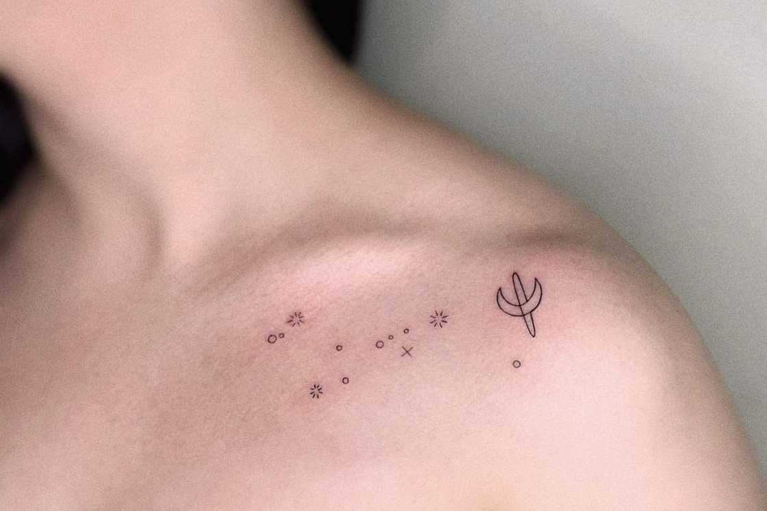 Scattered small astrology shoulder tattoo Scattered small astrology shoulder tattoo