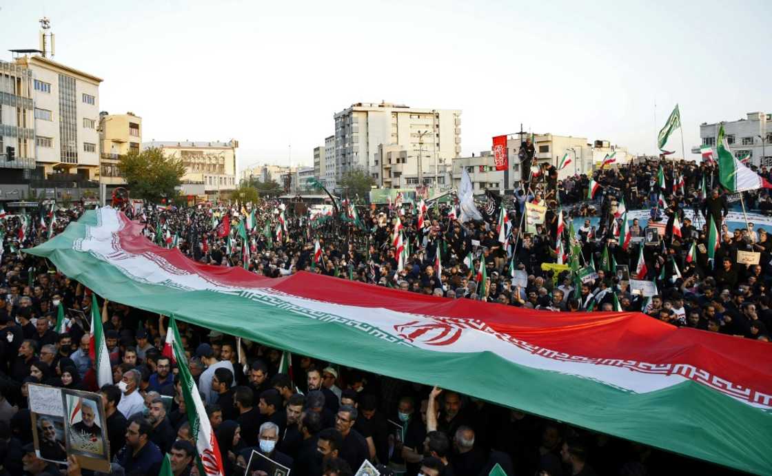 Pro-government protesters hold Iran's national flag during a rally in Tehran Pro-government protesters hold Iran's national flag during a rally in Tehran