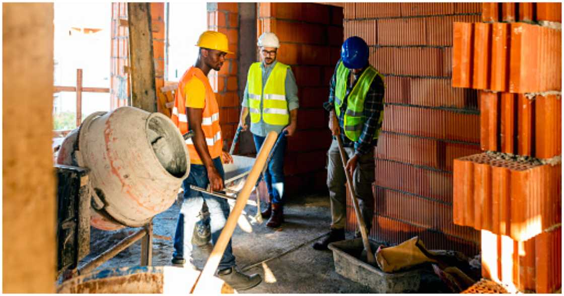 Men mixing concrete