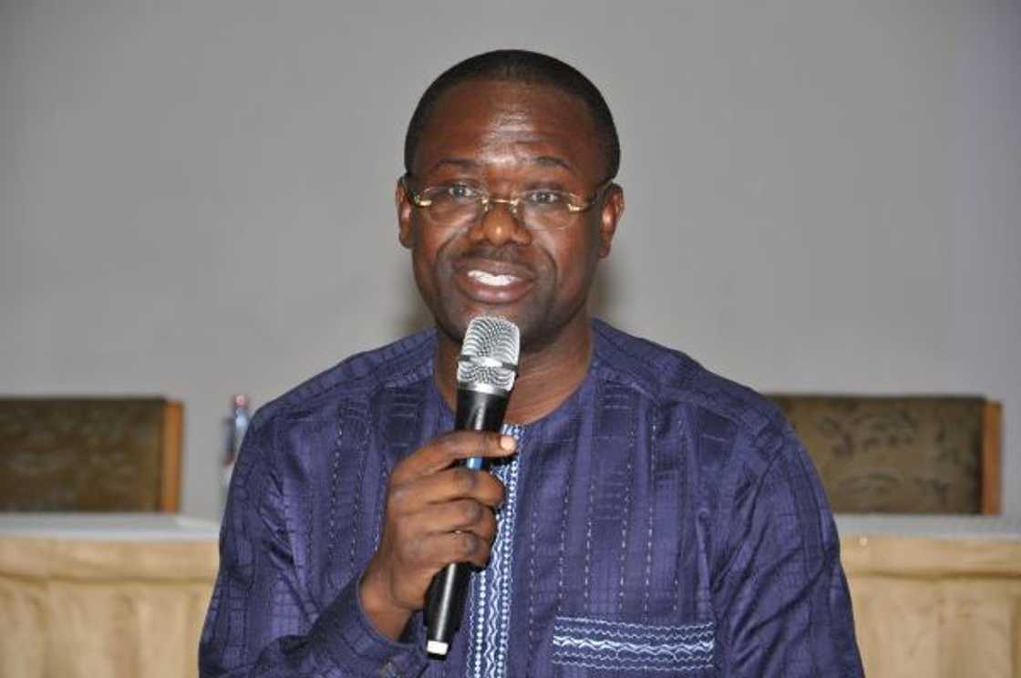 A man holding a microphone A man holding a microphone