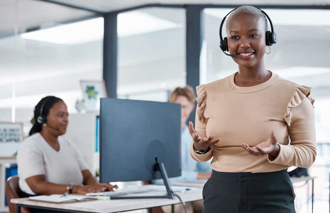 A trainer leads a session in a call centre office. A trainer leads a session in a call centre office.