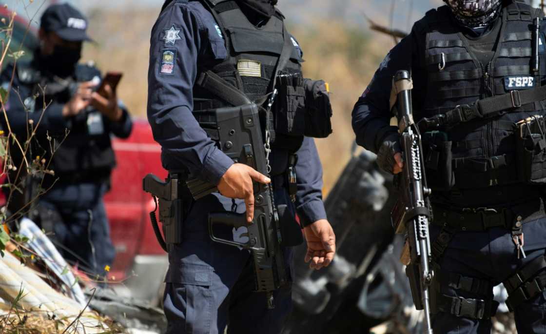 Police protect members of the 'Hasta Encontrarte' (Until we find you) collective searching for missing relatives in Mexico's Guanajuato state