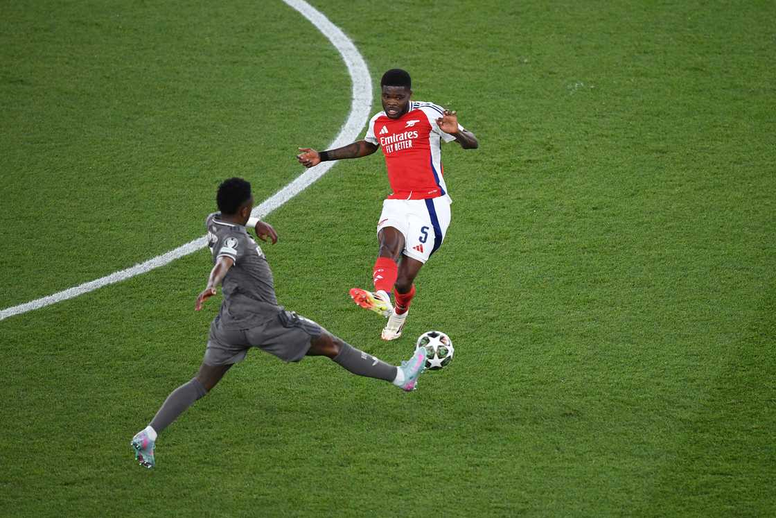 Thomas Partey passes the ball under pressure from Vinicius Junior during the UEFA Champions League 2024/25 Quarter Final First Leg match between Arsenal FC and Real Madrid C.F. at Emirates Stadium on April 8, 2025 Thomas Partey passes the ball under pressure from Vinicius Junior during the UEFA Champions League 2024/25 Quarter Final First Leg match between Arsenal FC and Real Madrid C.F. at Emirates Stadium on April 8, 2025