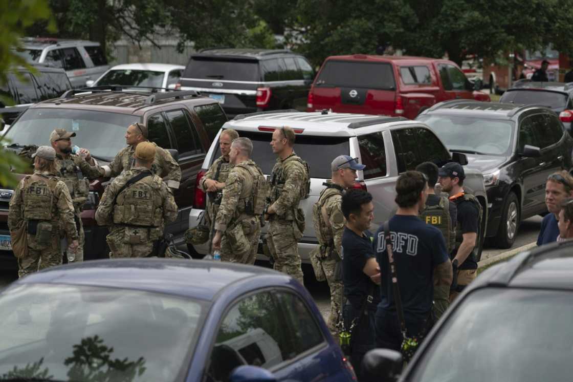 Officers gather at the scene of the Fourth of July parade shooting in Highland Park, Illinois on July 4, 2022 Officers gather at the scene of the Fourth of July parade shooting in Highland Park, Illinois on July 4, 2022