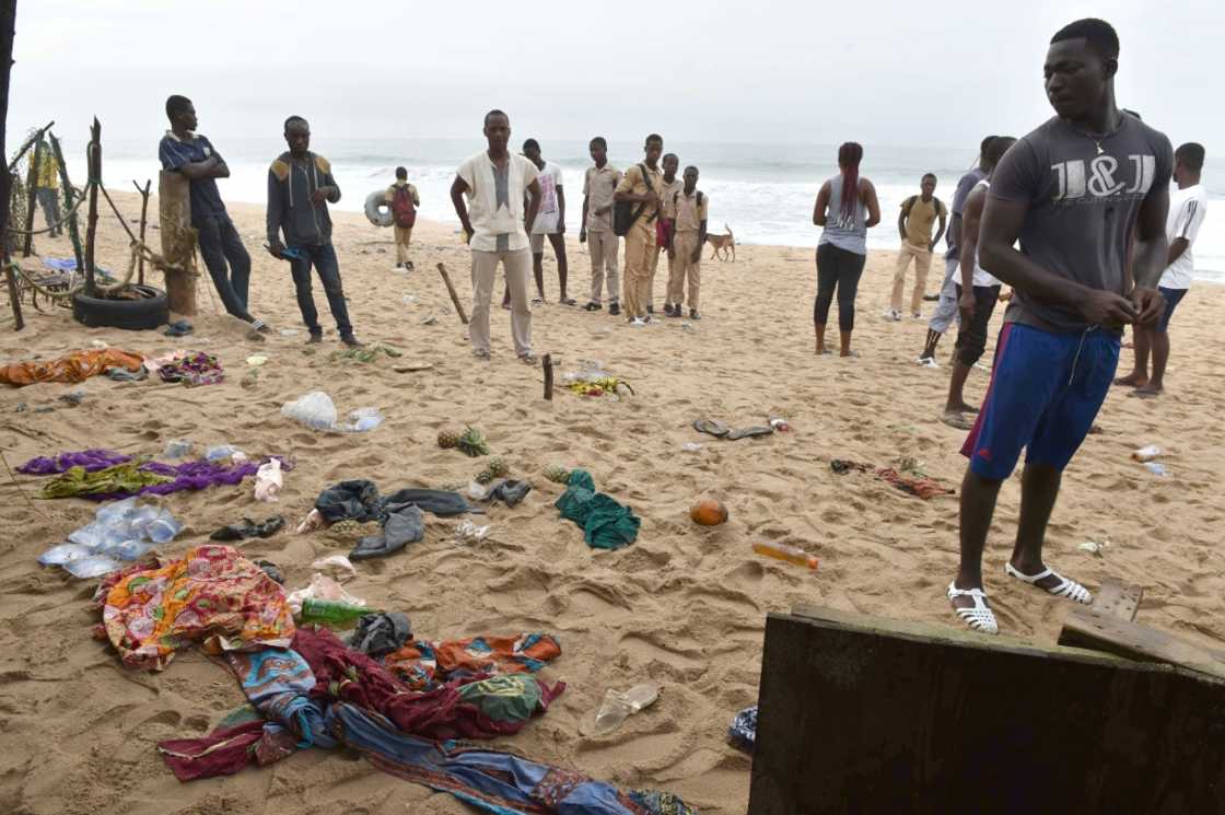 People look at clothes left on the beach following the attack People look at clothes left on the beach following the attack