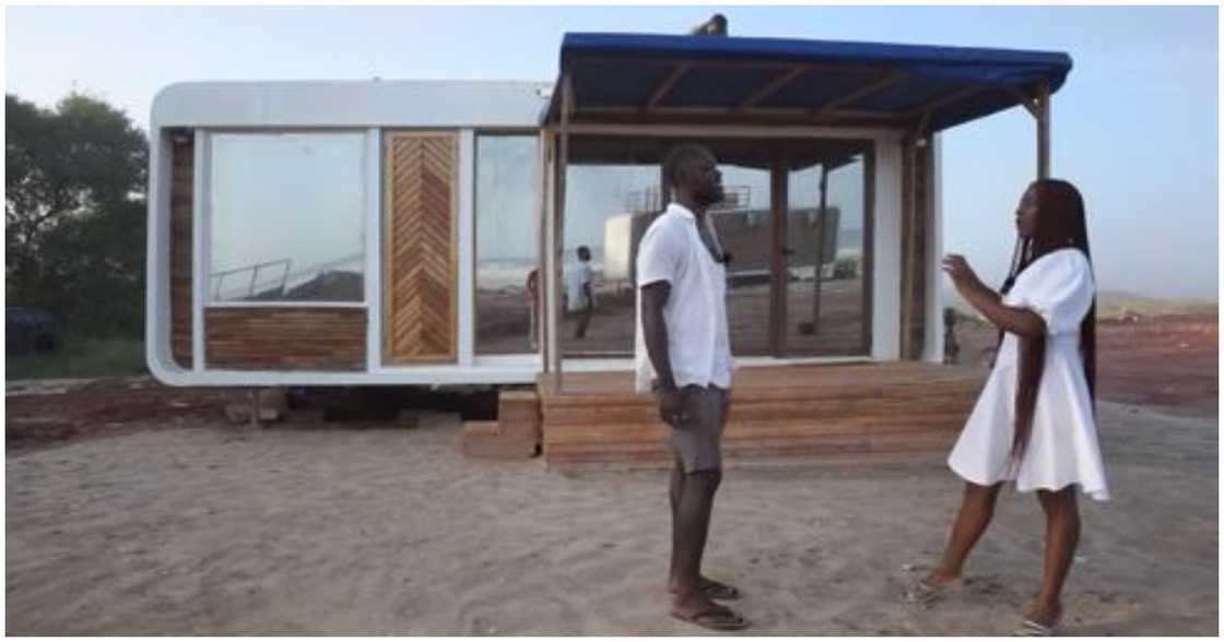 Brown and an interview host stand infront of the transportable house Brown and an interview host stand infront of the transportable house