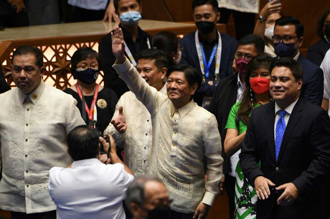 Philippine president-elect Ferdinand Marcos Jr (C) waves to supporters as he arrives for his proclamation as the country's president Philippine president-elect Ferdinand Marcos Jr (C) waves to supporters as he arrives for his proclamation as the country's president