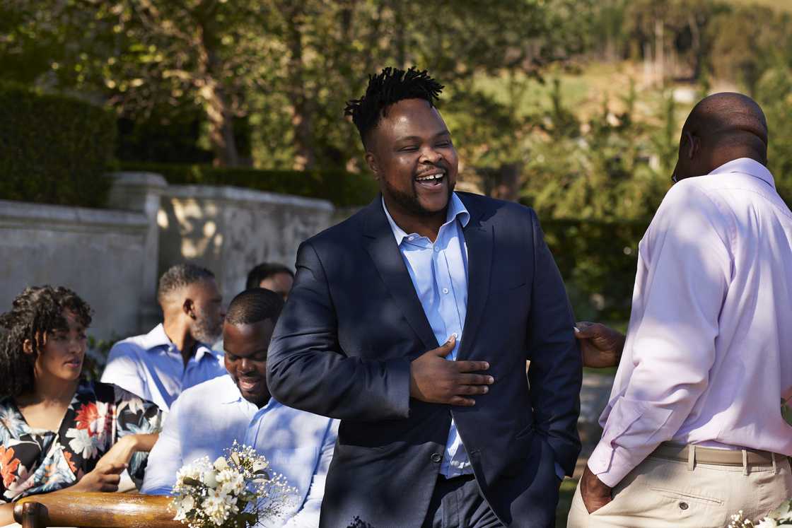 A man in formals standing during a wedding ceremony A man in formals standing during a wedding ceremony