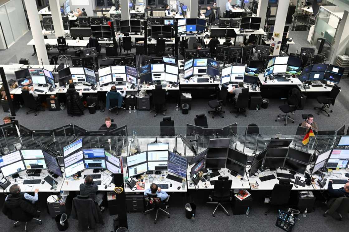 Traders work at the Stuttgart Stock Exchange