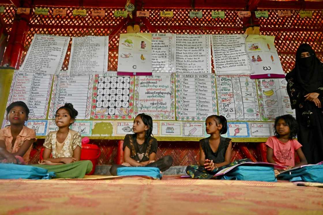 Rohingya children living in Bangladeshi refugee camps are made to sing Myanmar's national anthem before class