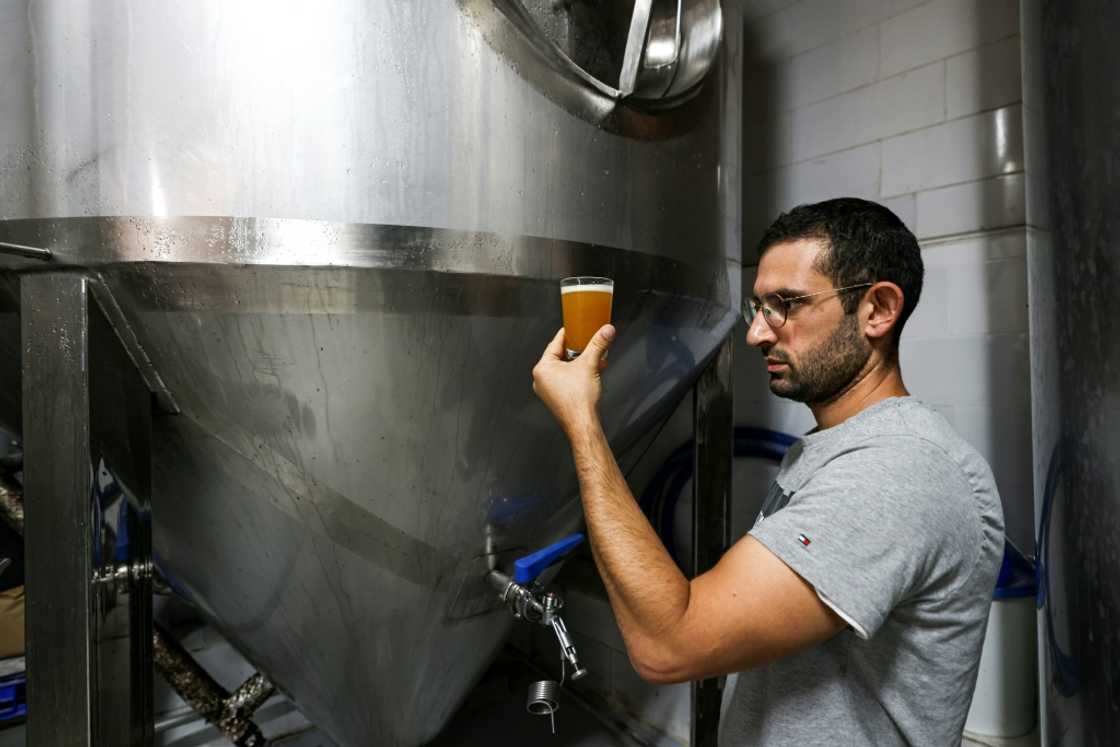 Kanaan Khoury, the son of the brewery founder, checks the beer at the brewery in the village of Taybeh, which means 'it's delicious' in Arabic Kanaan Khoury, the son of the brewery founder, checks the beer at the brewery in the village of Taybeh, which means 'it's delicious' in Arabic