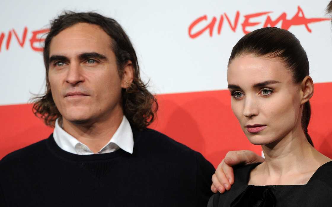 Joaquin Phoenix (L) and Rooney Mara (R) pose during the 'Her' Photocall at the 8th Rome Film Festival