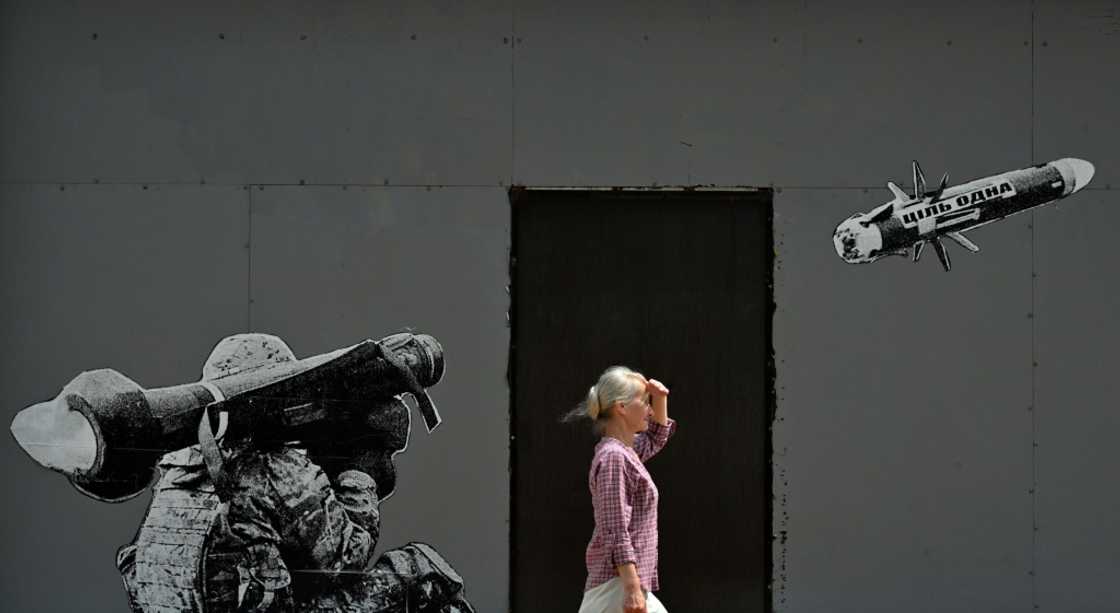 A woman walks past a mural in Kyiv depicting a Ukrainian serviceman firing a US-made Javelin anti-tank missile in July 2022 A woman walks past a mural in Kyiv depicting a Ukrainian serviceman firing a US-made Javelin anti-tank missile in July 2022