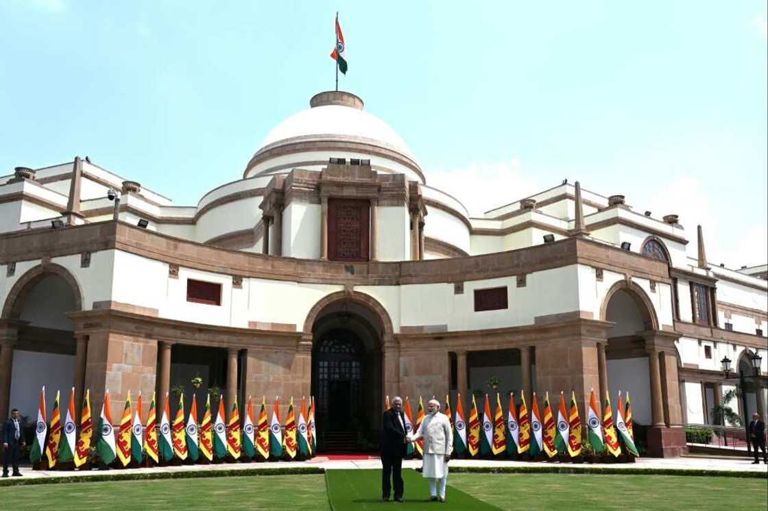 Sri Lanka's President Ranil Wickremesinghe (L) shakes hands with India's Prime Minister Narendra Modi before a meeting in New Delhi Sri Lanka's President Ranil Wickremesinghe (L) shakes hands with India's Prime Minister Narendra Modi before a meeting in New Delhi