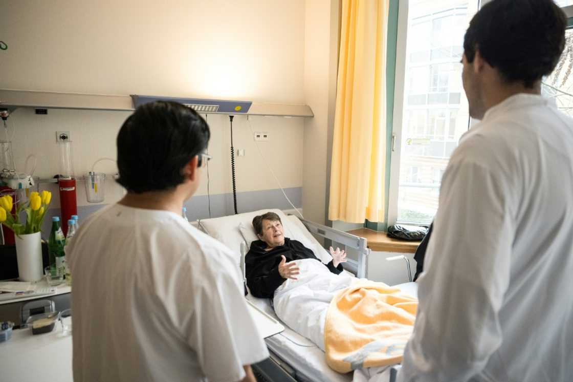 Mexican doctor and neurologist in training Mario de la Piedra Walter (R) and nursing professional Lorenzo Santiago Fernandez Yam from Mexico chat with patient Sibylle Hasenbein at a hospital Berlin on February 13, 2025 in Berlin. National elections on February 23, 2025 are expected to deliver victory for the conservative CDU/CSU bloc and a strong second-place showing for the far-right Alternative for Germany (AfD). Both parties have promised a crackdown on immigration, with the AfD campaigning in parts of the country with fake plane tickets to send illegal migrants on a one-way journey home. Hospital managers are "worried" that tensions over immigration will make it harder for Germany to recruit enough skilled workers from abroad to fill a growing labour shortage. Mexican doctor and neurologist in training Mario de la Piedra Walter (R) and nursing professional Lorenzo Santiago Fernandez Yam from Mexico chat with patient Sibylle Hasenbein at a hospital Berlin on February 13, 2025 in Berlin. National elections on February 23, 2025 are expected to deliver victory for the conservative CDU/CSU bloc and a strong second-place showing for the far-right Alternative for Germany (AfD). Both parties have promised a crackdown on immigration, with the AfD campaigning in parts of the country with fake plane tickets to send illegal migrants on a one-way journey home. Hospital managers are "worried" that tensions over immigration will make it harder for Germany to recruit enough skilled workers from abroad to fill a growing labour shortage.