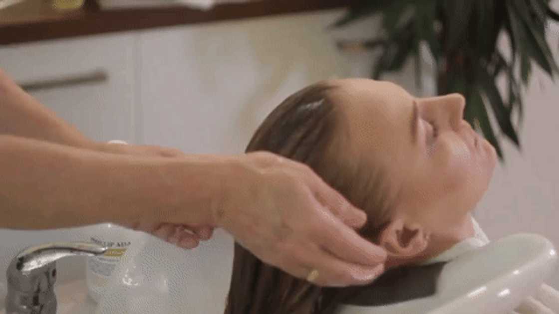 A woman getting her hair conditioned