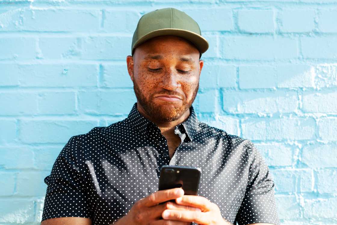 A man is reacting to his smart phone A man is reacting to his smart phone