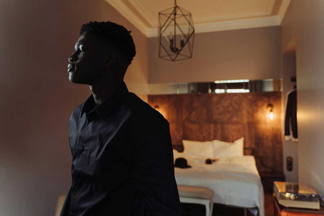 A stressed man standing indoors