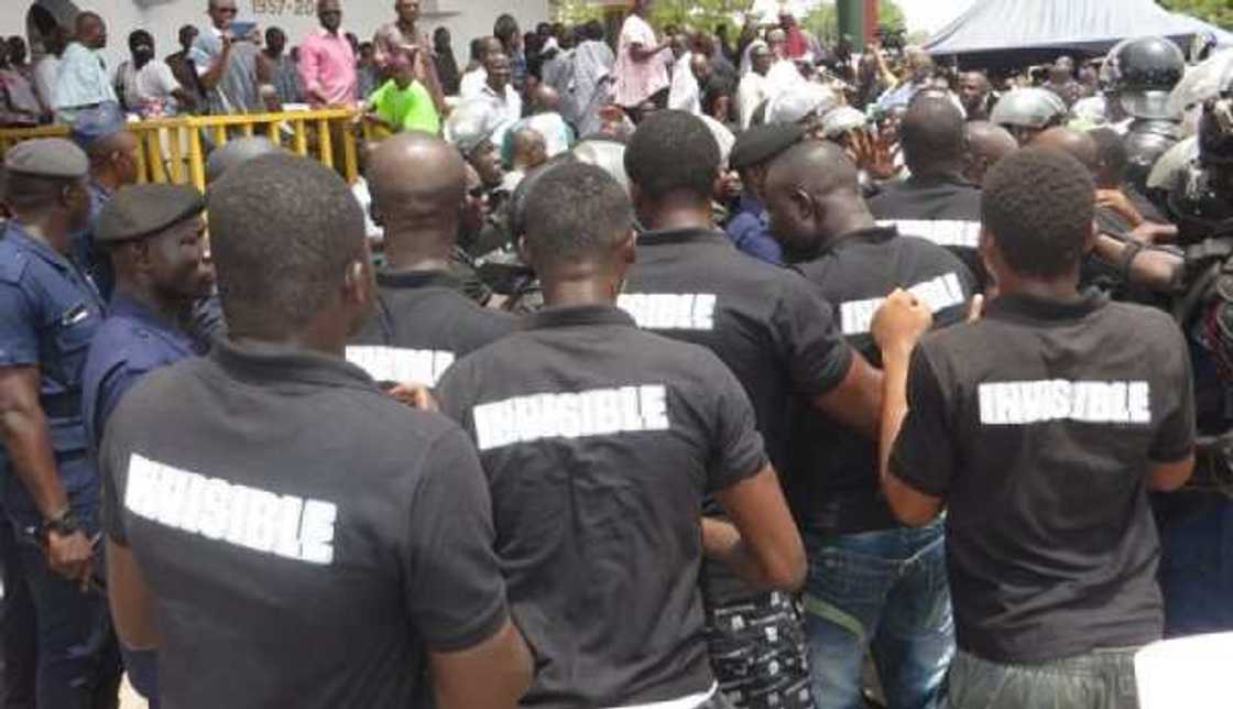 A group of men wearing black shirts