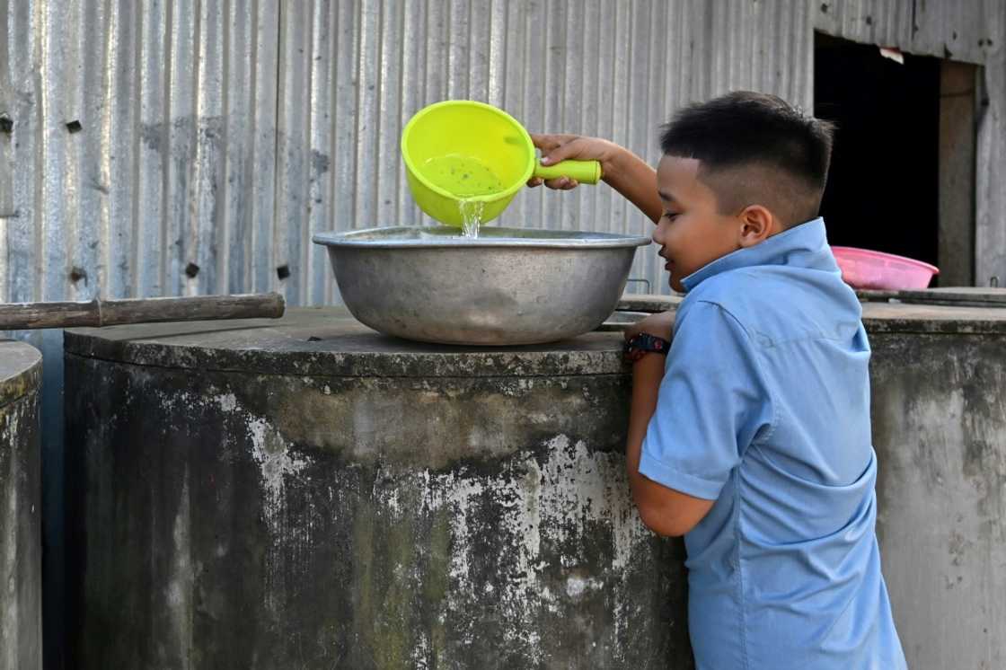 A young boy collects fresh water from a tank in Ben Tre province, where some are now forced to buy water for even domestic needs A young boy collects fresh water from a tank in Ben Tre province, where some are now forced to buy water for even domestic needs