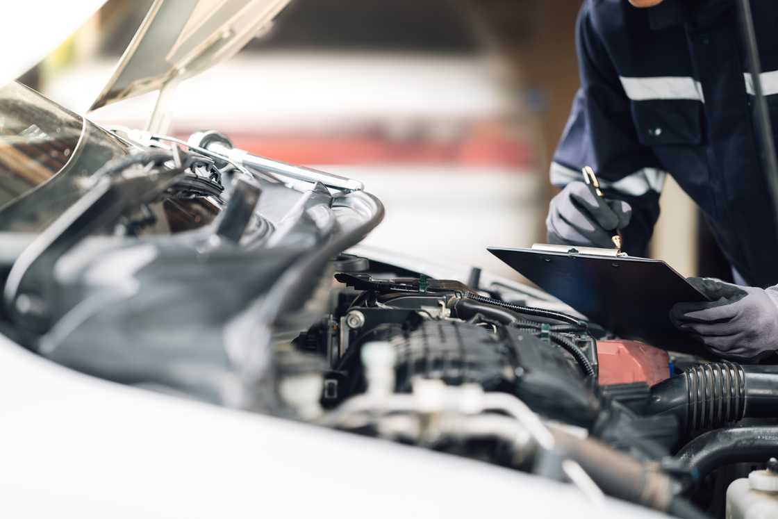 A mechanic is checking a vehicle