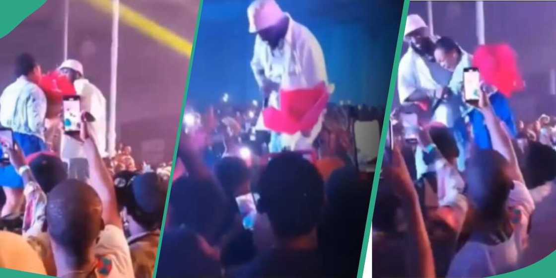 Davido hugs female fan who gave him flowers during his Asaba concert.