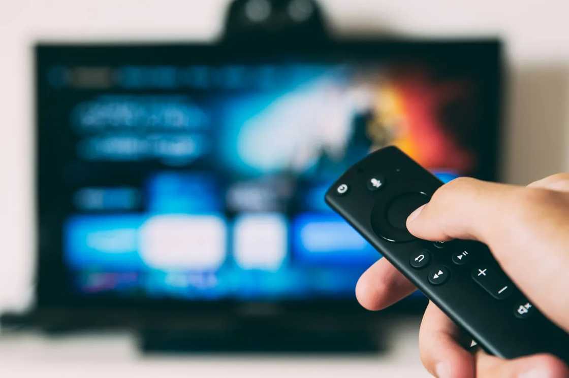 A person holding a remote control