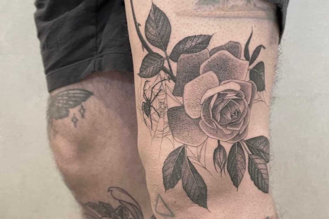 A black and grey rose thigh tattoo A black and grey rose thigh tattoo