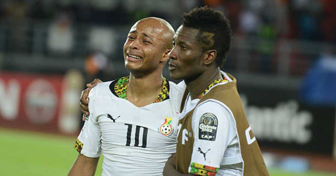 Asamoah Gyan consoles Andre Ayew. Asamoah Gyan consoles Andre Ayew.