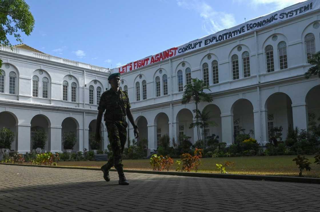 A cadet walks in front of the Sri Lankan president’s official residence on Friday after it was overrun by protesters last weekend A cadet walks in front of the Sri Lankan president’s official residence on Friday after it was overrun by protesters last weekend