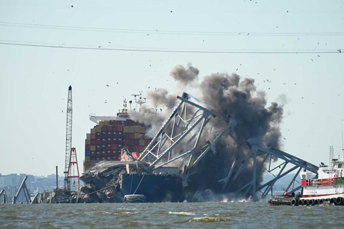 Crews conduct a controlled demolition of a section of the Francis Scott Key Bridge resting on the Dali container ship in Baltimore on May 13, 2024