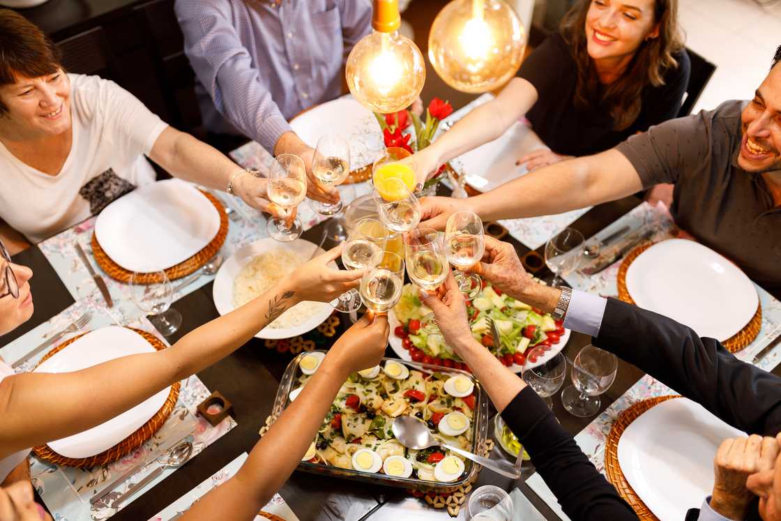 Family toasting on dinner table