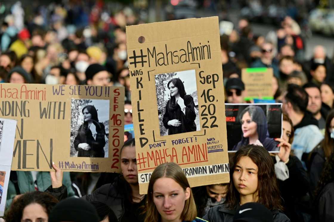 Demonstrators in Berlin hold up placards with images of Mahsa Amini in Berlin Demonstrators in Berlin hold up placards with images of Mahsa Amini in Berlin