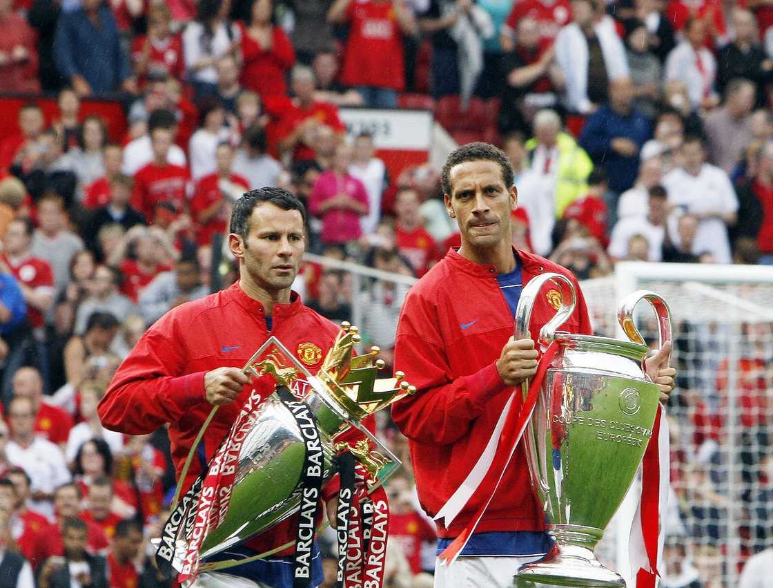 Ryan Giggs (L) and Rio Ferdinand (R) displayig the 2008 UEFA Champions League and Premier League Manchester United won Ryan Giggs (L) and Rio Ferdinand (R) displayig the 2008 UEFA Champions League and Premier League Manchester United won