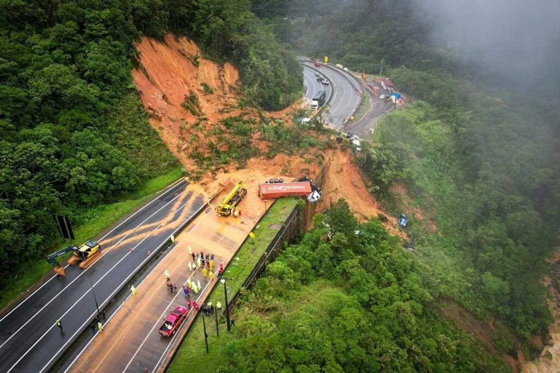 Aerial view of the landslide that hit highway BR 367 in southern Brazil, sweeping away some 20 vehicles and leaving at least two people dead and dozens missing. Aerial view of the landslide that hit highway BR 367 in southern Brazil, sweeping away some 20 vehicles and leaving at least two people dead and dozens missing.