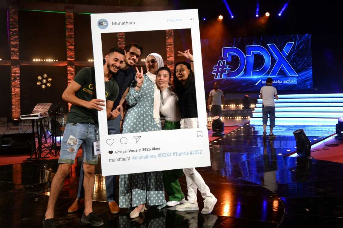Participants pose for a photo with a cutout frame depicting an Instagram social media post on the set of the #DDX talent show Participants pose for a photo with a cutout frame depicting an Instagram social media post on the set of the #DDX talent show
