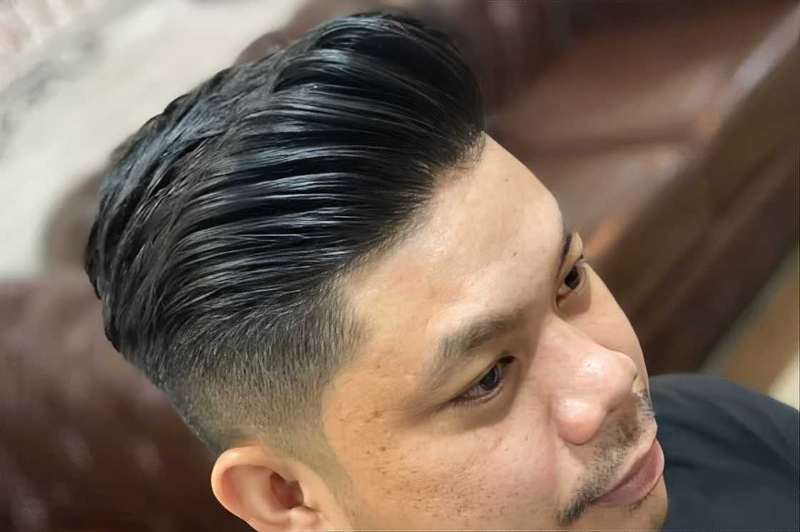 An Asian man is rocking a pompadour hairdo