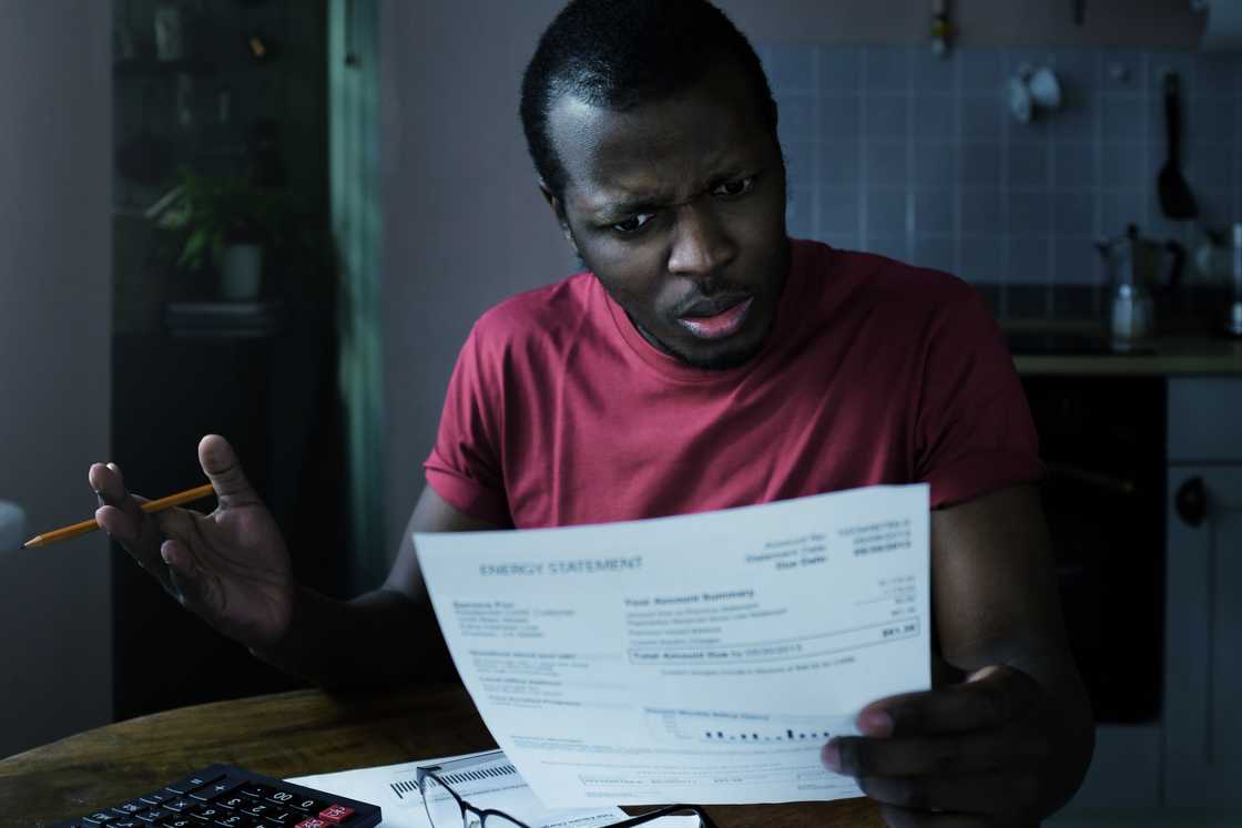A shocked man reading a document