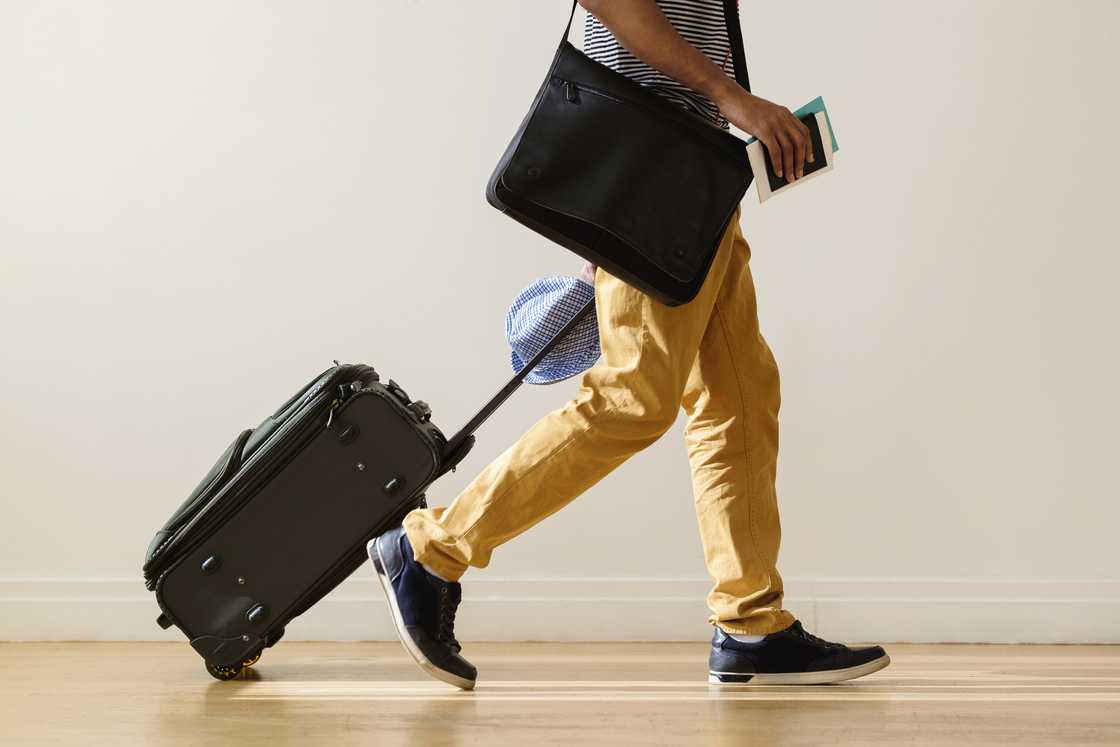 A businessman rolling luggage