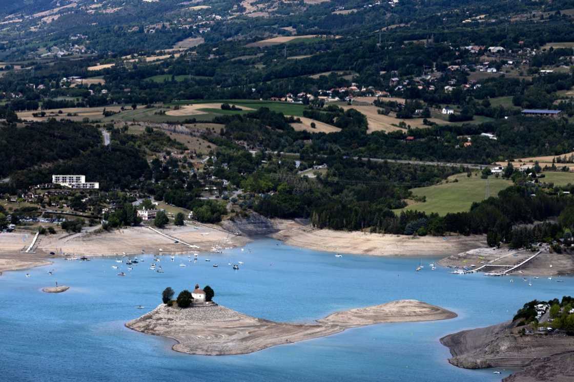 The Saint-Michel Chapel on a small island in the Serre-Poncon lake in the French Alps is seen in August 2022 after drought pushed down the the water level by 14 meters amid rising global concerns on climate change The Saint-Michel Chapel on a small island in the Serre-Poncon lake in the French Alps is seen in August 2022 after drought pushed down the the water level by 14 meters amid rising global concerns on climate change