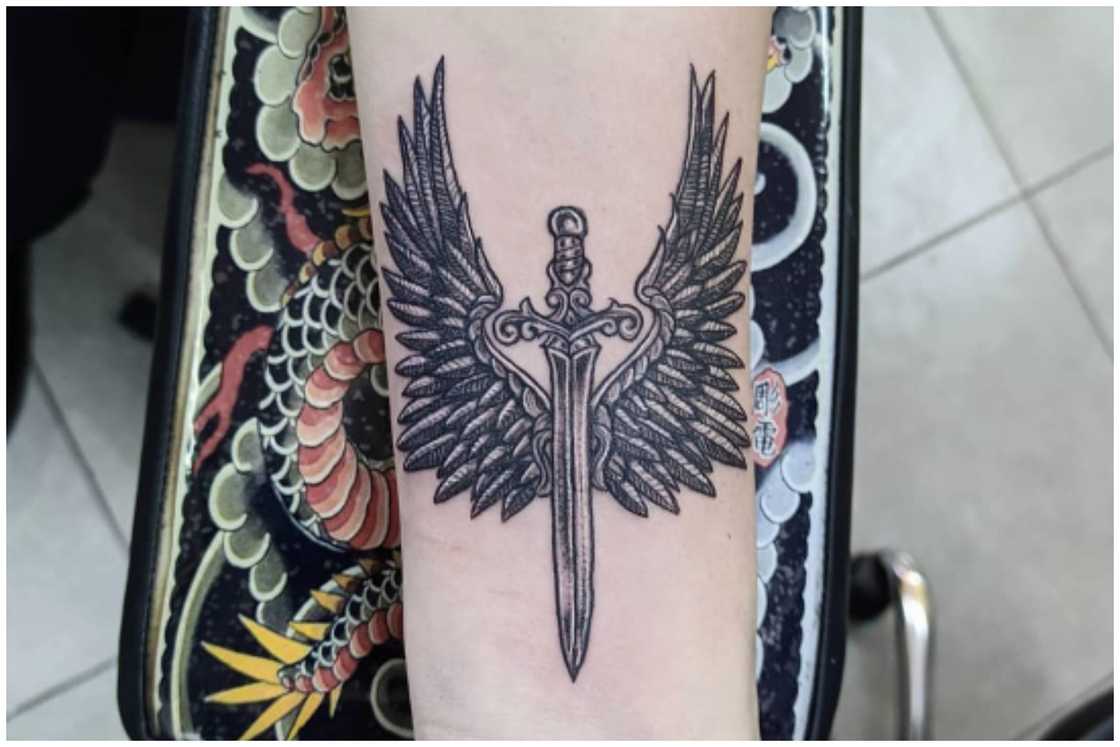 Dagger and wings tattoo