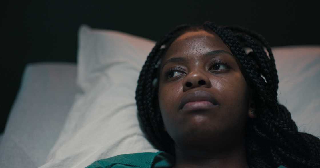 A woman lies awake thinking about her stokvel.