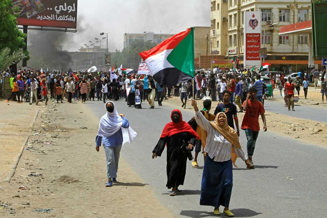 Sudanese anti-coup protesters march during a demonstration in Omdurman, the capital Khartoum's twin city, on June 30