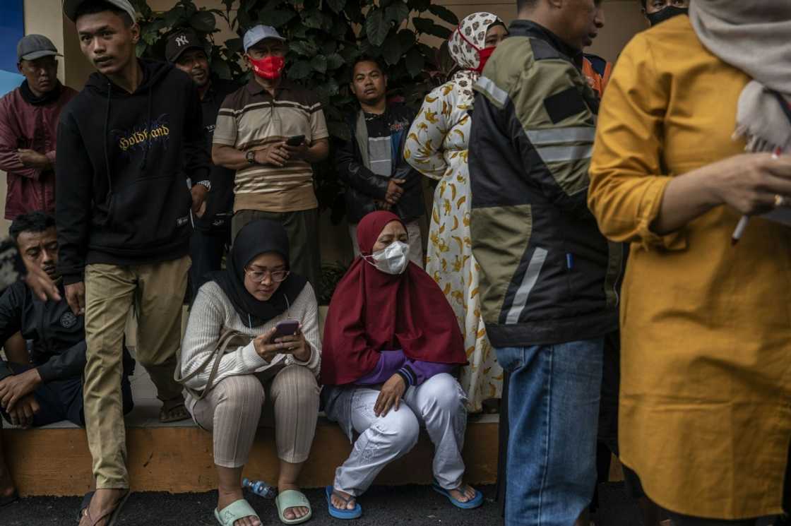 As night fell, the hustle and bustle at the hospital died down. Relatives laid on mats and covered up with blankets to get some rest outside the facility