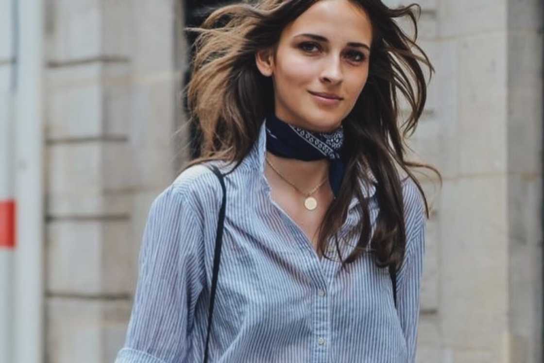 A lady is wearing a bandana on her neck A lady is wearing a bandana on her neck