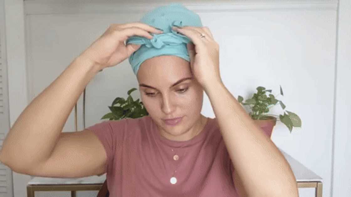 A woman unwrapping her hair