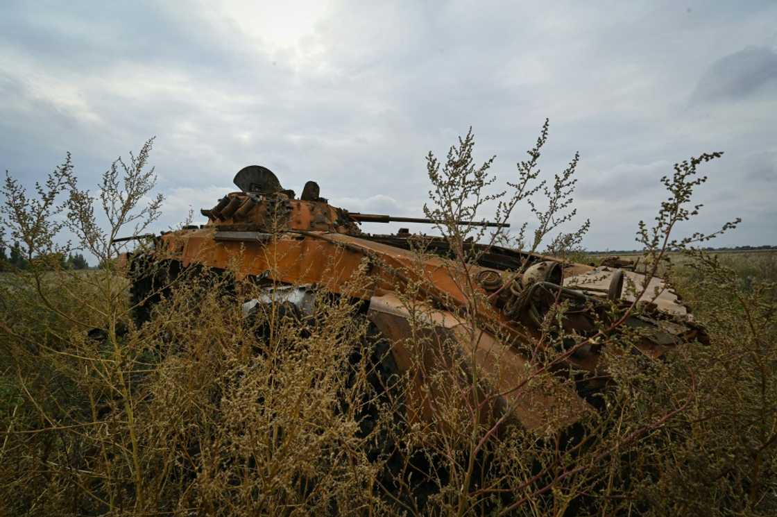 A Russian tank lies on the village's outskirts A Russian tank lies on the village's outskirts