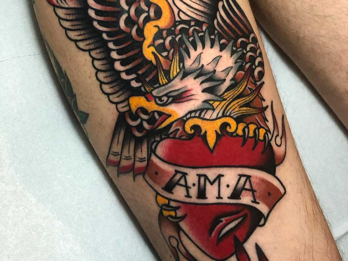 Colourful leg traditional Sacred Heart with eagle tattoo